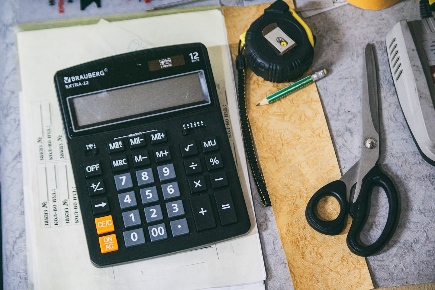 Small business team reviewing CRM budget and costs around a desk in a modern office