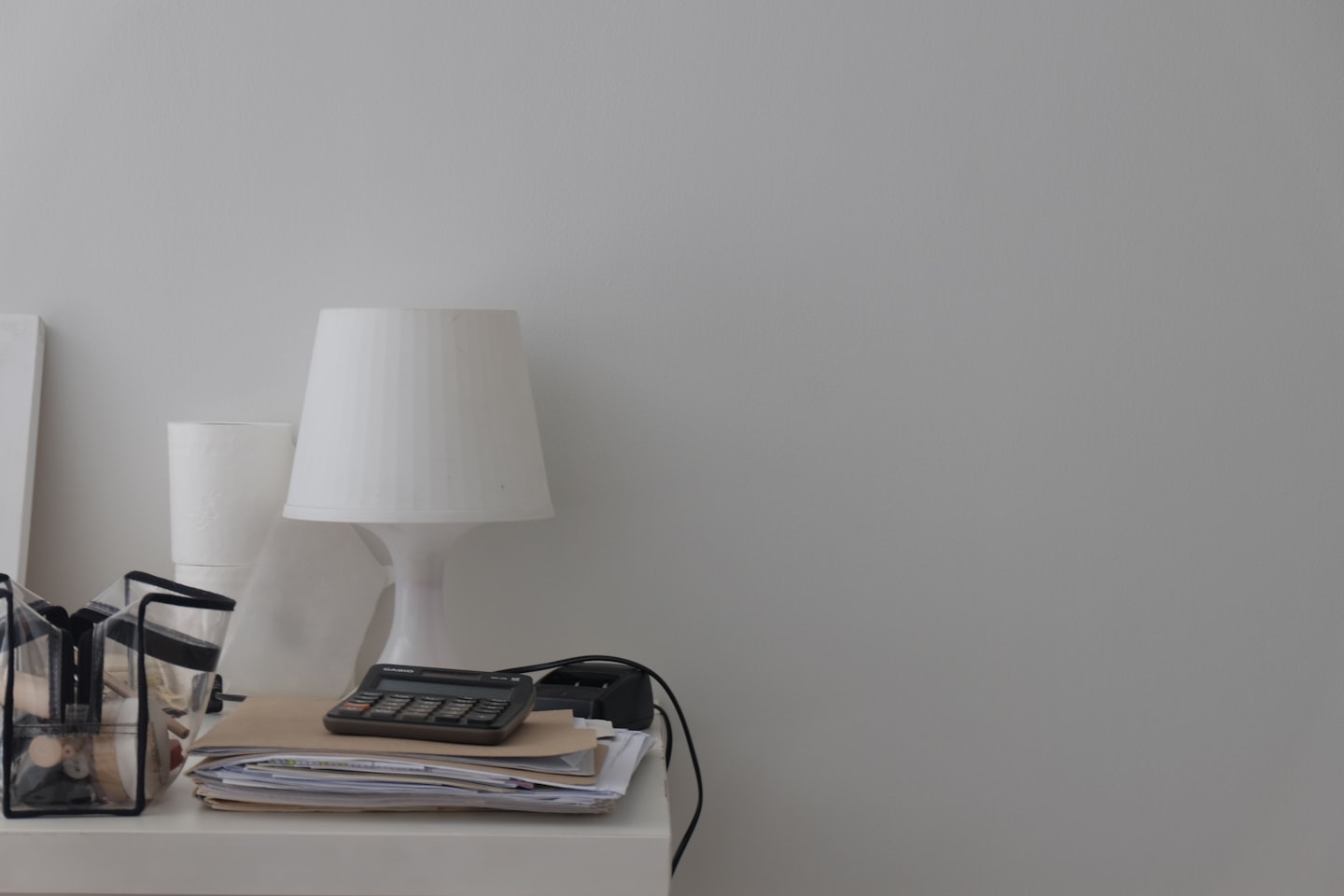 A calculator and laptop on a desk representing CRM pricing and total cost evaluation