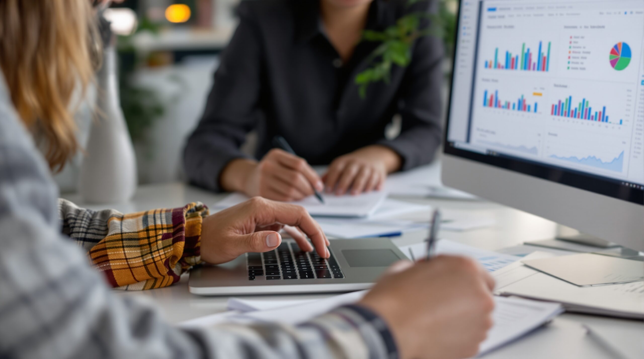 Modern workspace with laptop and organized sales planning materials for comparing CRM with manual tracking